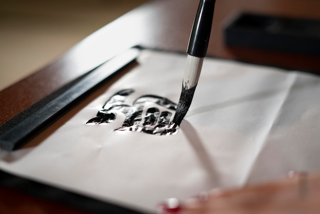 Free Photo close up on person doing  japanese calligraphy, called shodo