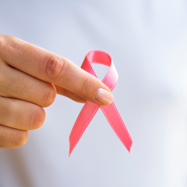 Close-up person holding awareness ribbon