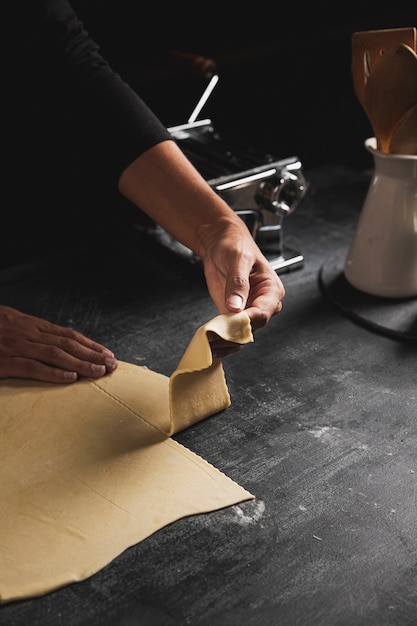 Free photo close-up person holding dough