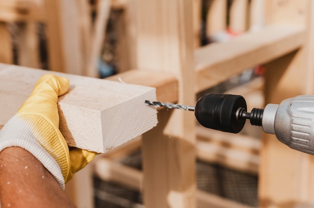 Close-up person holding a hammer drill