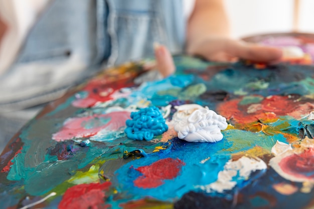 Close-up person holding painting palette