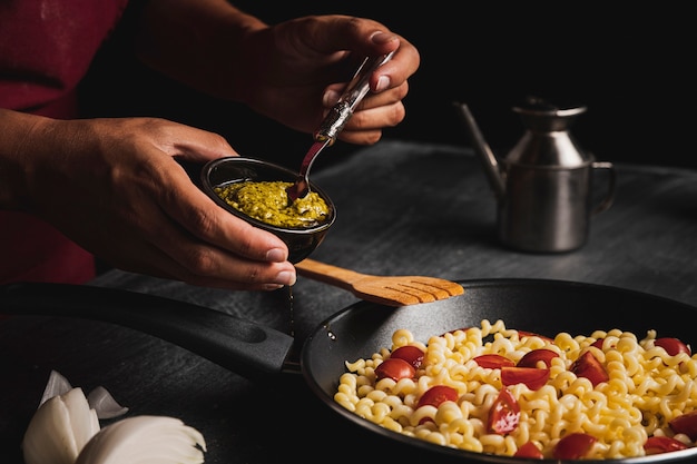 Free Photo close-up person holding sauce for pasta