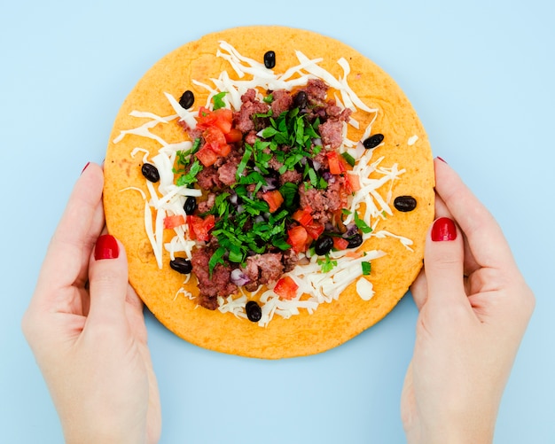 Free photo close-up person holding unfolded burrito