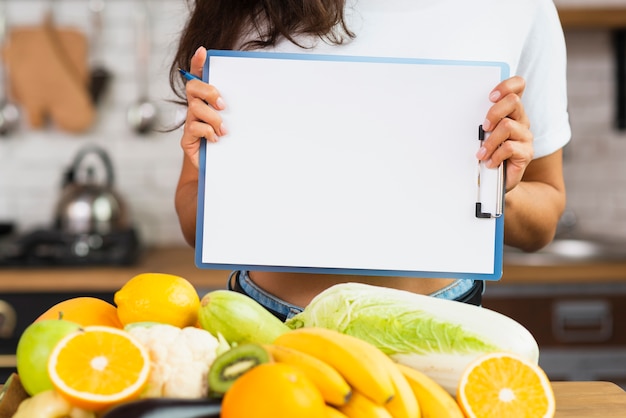 Free Photo close-up person holding up a clipboard