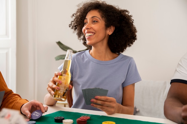 Close up on person playing poker with friends