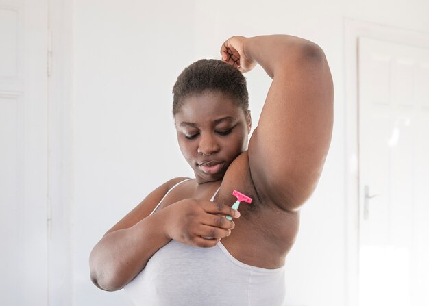 Close up on person removing hair armpit