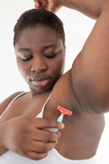 Close up on person removing hair armpit