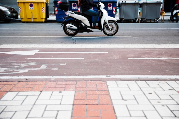 Close-up of a person riding the bike on road