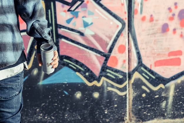 Free photo close-up of person's hand holding aerosol bottle