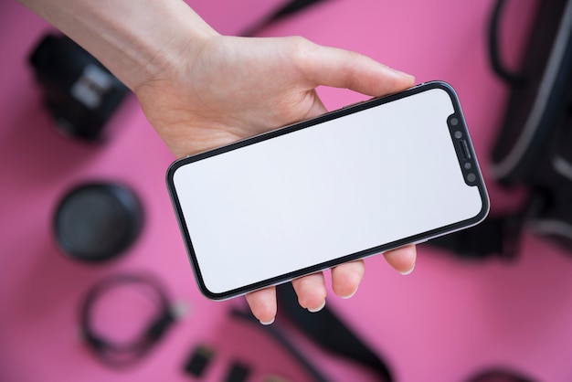 Close-up of a person's hand showing cellphone with blank screen