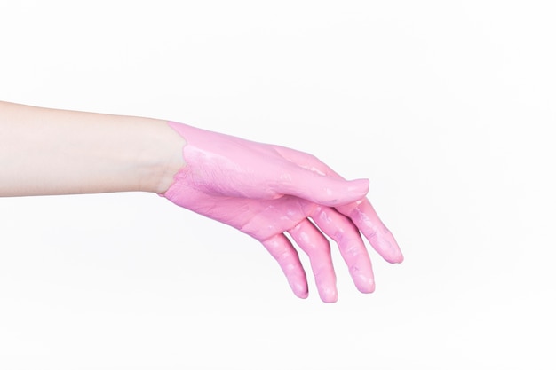 Free photo close-up of a person's hand with pink paint over white backdrop