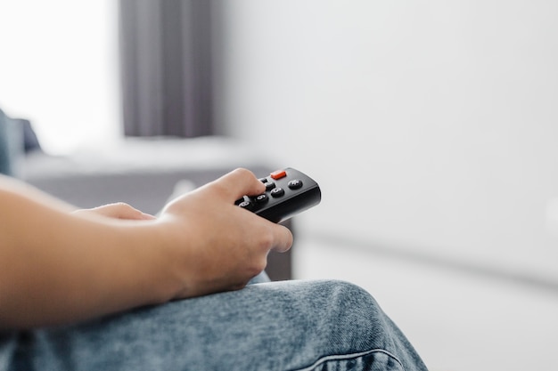 Close-up person using the television remote