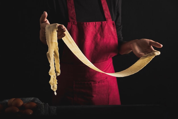 Free Photo close-up person with apron holding dough