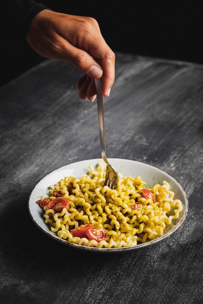 Close-up person with pasta bowl