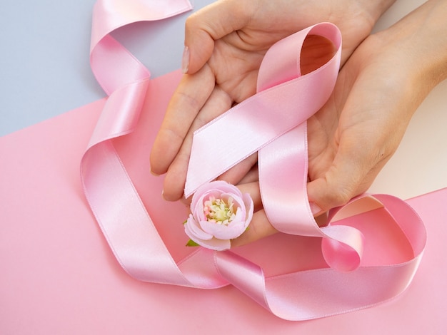 Close-up person with pink ribbon top view