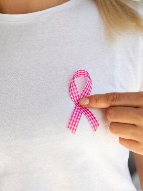 Free Photo close-up person with pink and white ribbon