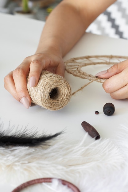 Close up on person working on dreamcatcher