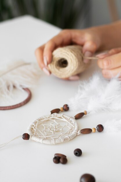 Close up on person working on dreamcatcher