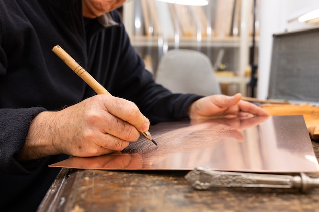 Free Photo close up on person working on engraving