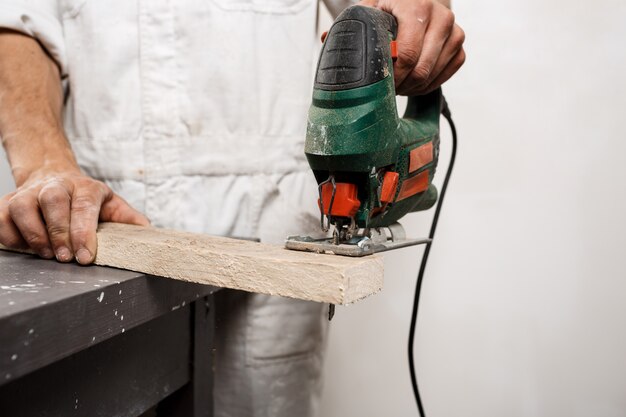 Close up photo of cutting wood with fretsaw.