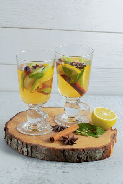 Close up photo of Fresh apple cocktail on wooden board. 