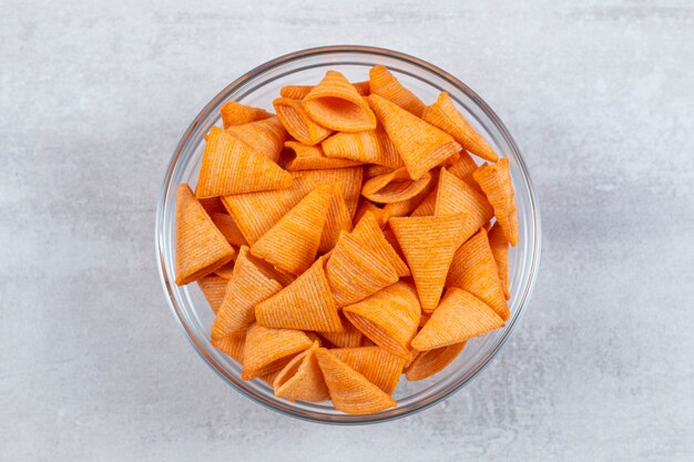 Close up photo of fresh fries in glasses bowl.