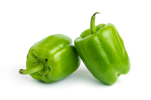 Close up photo of fresh organic peppers isolated on white surface.