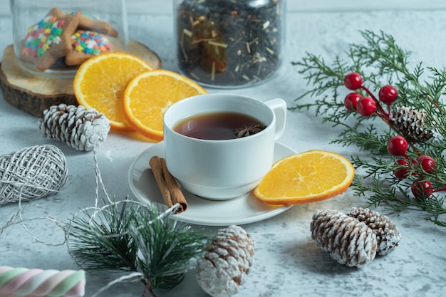 Close up photo of fresh tea with orange slices.