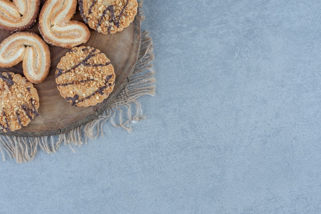 Close up photo of homemade sesame cookies on wooden board.