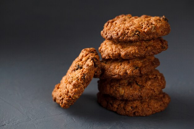 Close-up photo of oatmeal cookies stack on gray surface