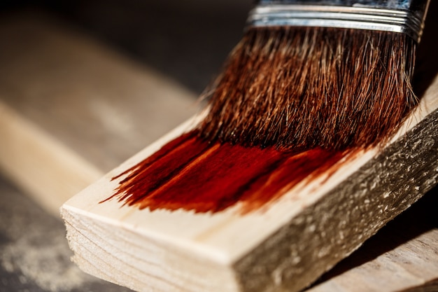 Close up photo of painting wood in brown color.