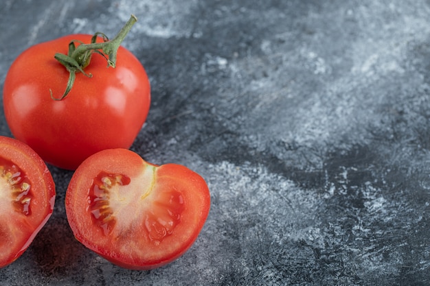 Close up photo of Red fresh tomatoes whole or cut. High quality photo