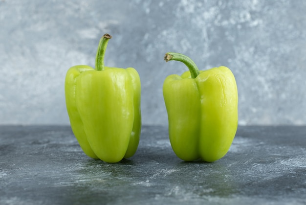 Close up photo of two fresh organic peppers . 