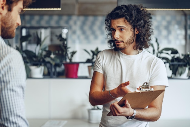 Free Photo close up photo of two male colleagues discussing project in office