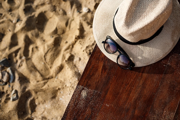 Free photo close-up picture of hat and glasses on beach