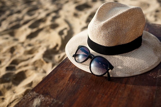 Free photo close-up picture of hat and glasses on beach