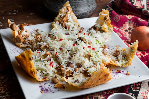 Free Photo close-up pilaf in a pita with meat, beans and spices. traditional oriental dish on a dark wooden table horizontal