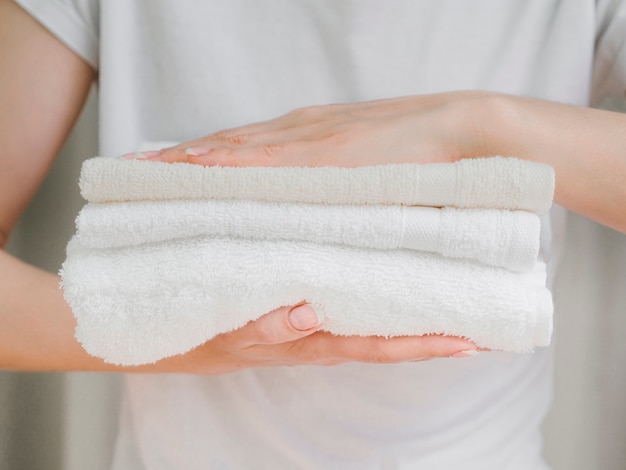 Close up pile of towels between hands