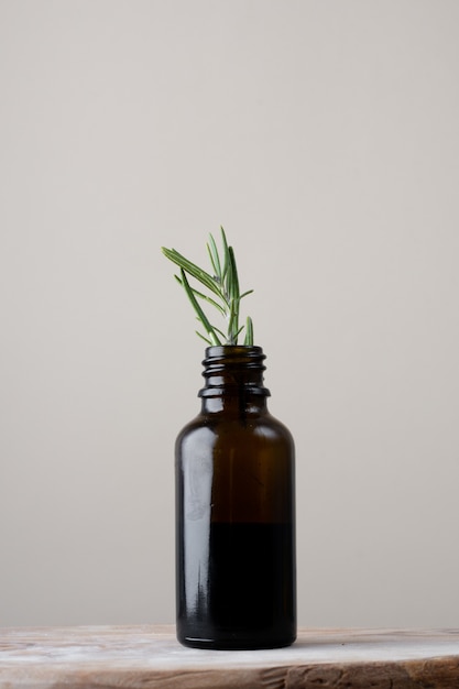 Close-up plastic bottle with rosemary