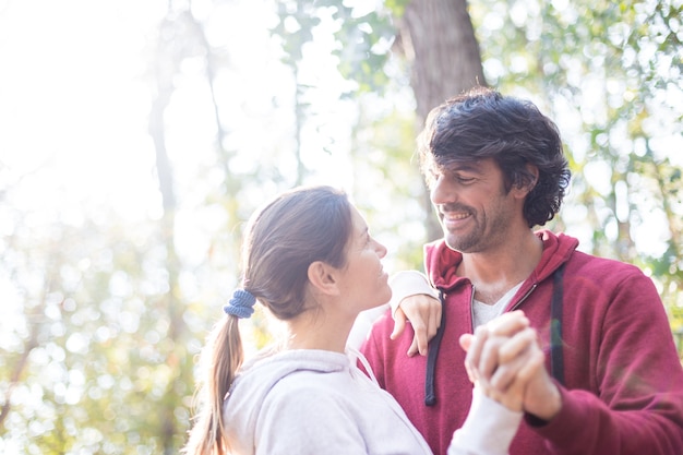 Close-up of playful man dancing with his wife