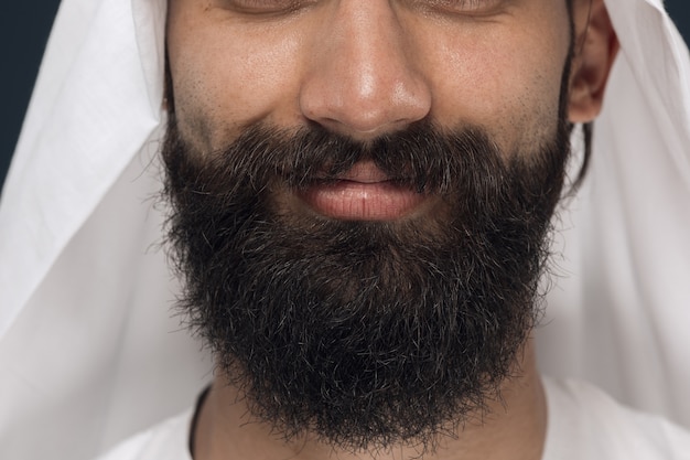 Free Photo close up portrait of arabian saudi businessman. young male model's face with beard, smiling. concept of business, finance, facial expression, human emotions.