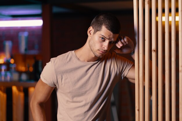 Close-up portrait of attractive male model. Young handsome man in a bar