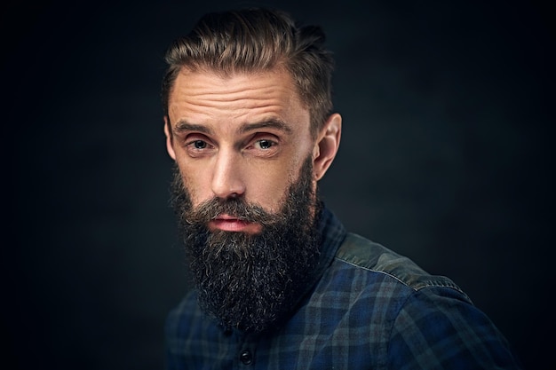 Free Photo close up portrait of bearded male with long hair over dark background.