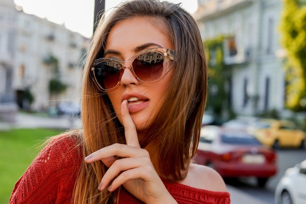 Close up  portrait of beautiful european woman in sunglasses  posing outdoor. Autumn mood. Windy hairs.