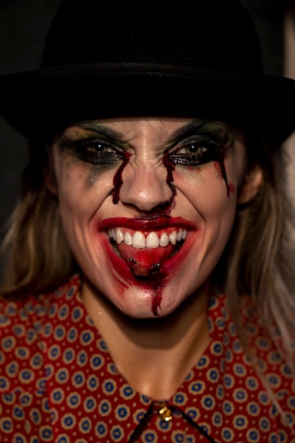 Free photo close-up portrait of clown woman sticking her tongue out