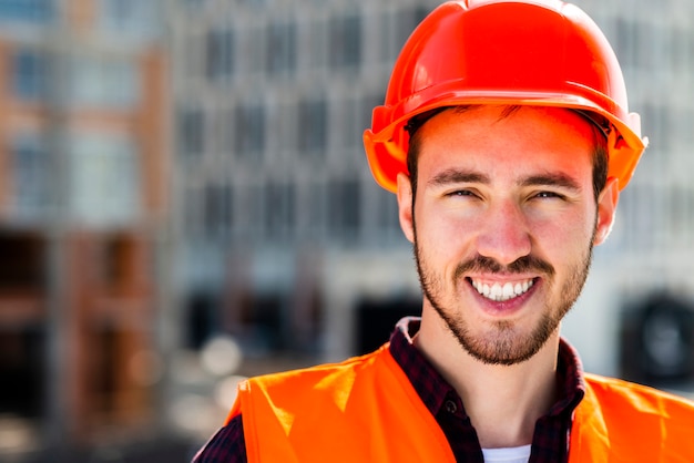 Close-up portrait of construction engineer looking at camera