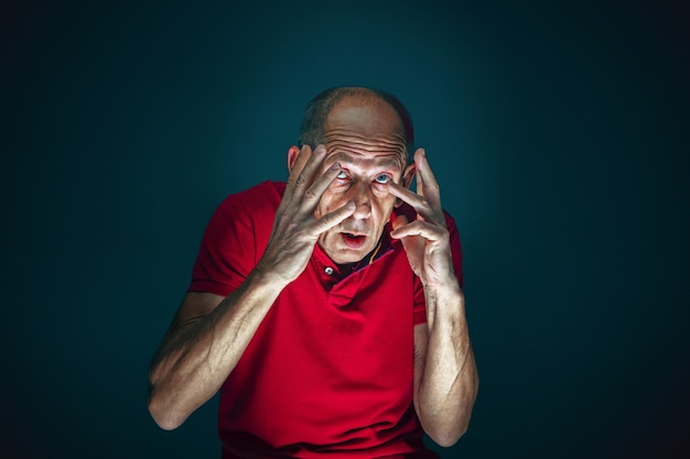 Free Photo close up portrait of crazy scared and shocked man isolated on dark