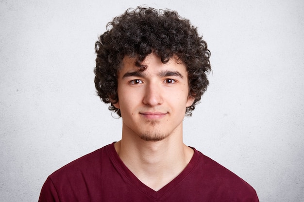 Close up portrait of curly handsome European male