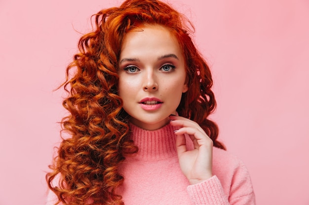 Close-up portrait of curly redhead woman with blue eyes