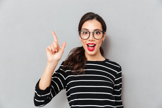 Close up portrait of an excited woman in eyeglasses